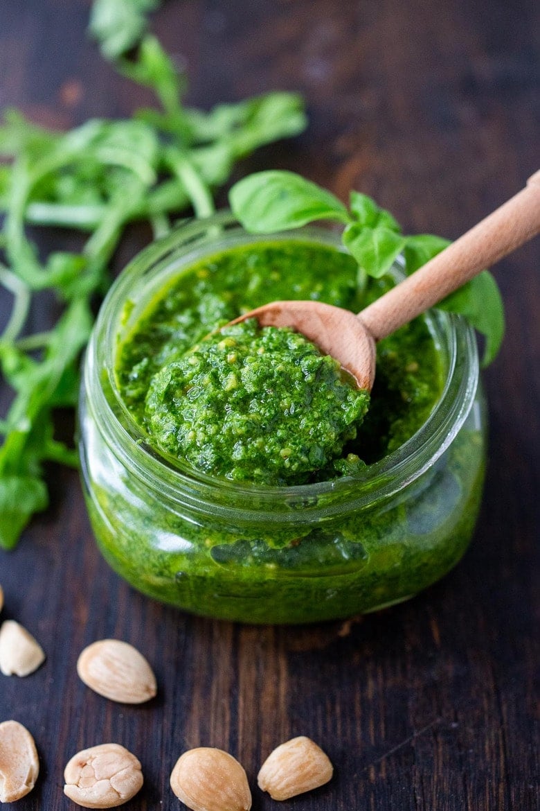 A delicious recipe for vegan Arugula Almond Pesto designed to enliven soups, stews, cassoulets, sandwiches and pasta dishes. It's dairy-free and made with almonds, basil and lemon zest adding a peppery brightness to dishes you are already making!