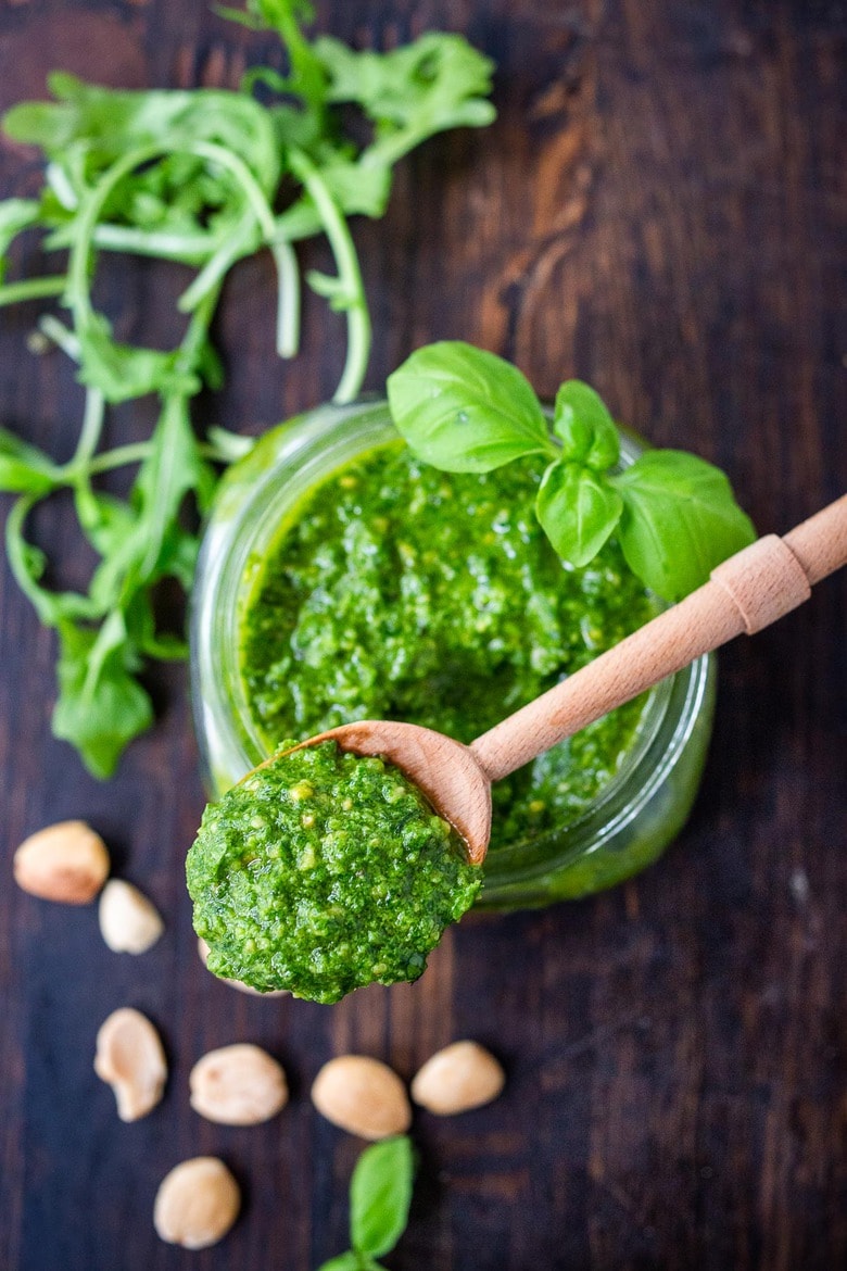  Arugula Almond Pesto designed to elevate soups, stews, cassoulets, sandwiches and pasta dishes. It's vegan and made with almonds, basil and lemon zest adding a peppery brightness to dishes you are already making! #pesto #arugula #veganpesto #arugulapesto #nopinenuts