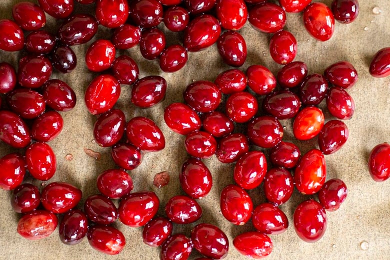 A festive holiday cocktail made with assertive rye whiskey, enlivened with tart cranberry & lemon, the whole softened by 2 festive liqueurs; garnished with a bit of holiday fruit, or (depending on how you've been this year) - a lump of "coal".