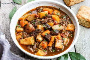 Get warm and cozy with this Instant Pot Beef Stew with Root Veggies- a hearty, comforting one-pot meal made in the pressure cooker, that is keto friendly, easy to make and full of depth and flavor. #beefstew #instantpotbeefstew #instantpot #bestbeefstew