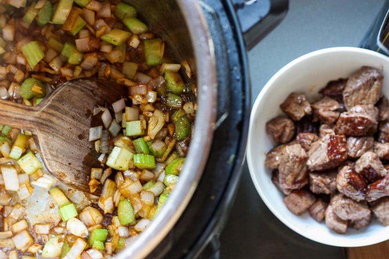 Get warm and cozy with this Instant Pot Beef Stew with Root Veggies- a hearty, comforting one-pot meal made in the pressure cooker, that is keto friendly, easy to make and full of depth and flavor. #beefstew #instantpotbeefstew #instantpot #bestbeefstew