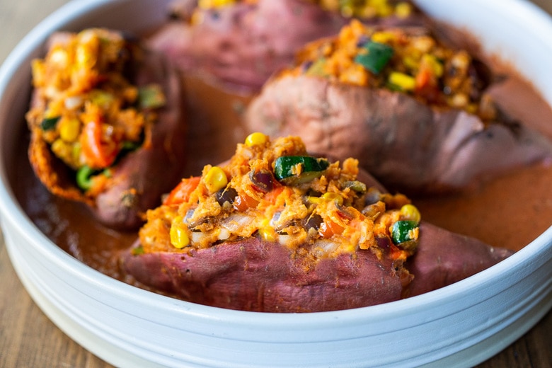 These Oaxacan-Style Baked Sweet Potatoes are loaded up with healthy veggies and infused with Oaxacan flavors, served up over optional 5-Minute Mole Sauce. Healthy, flavorful and perfect for Sunday meal prep to reheat during the busy week. Vegan-adaptable! Gluten-free. 