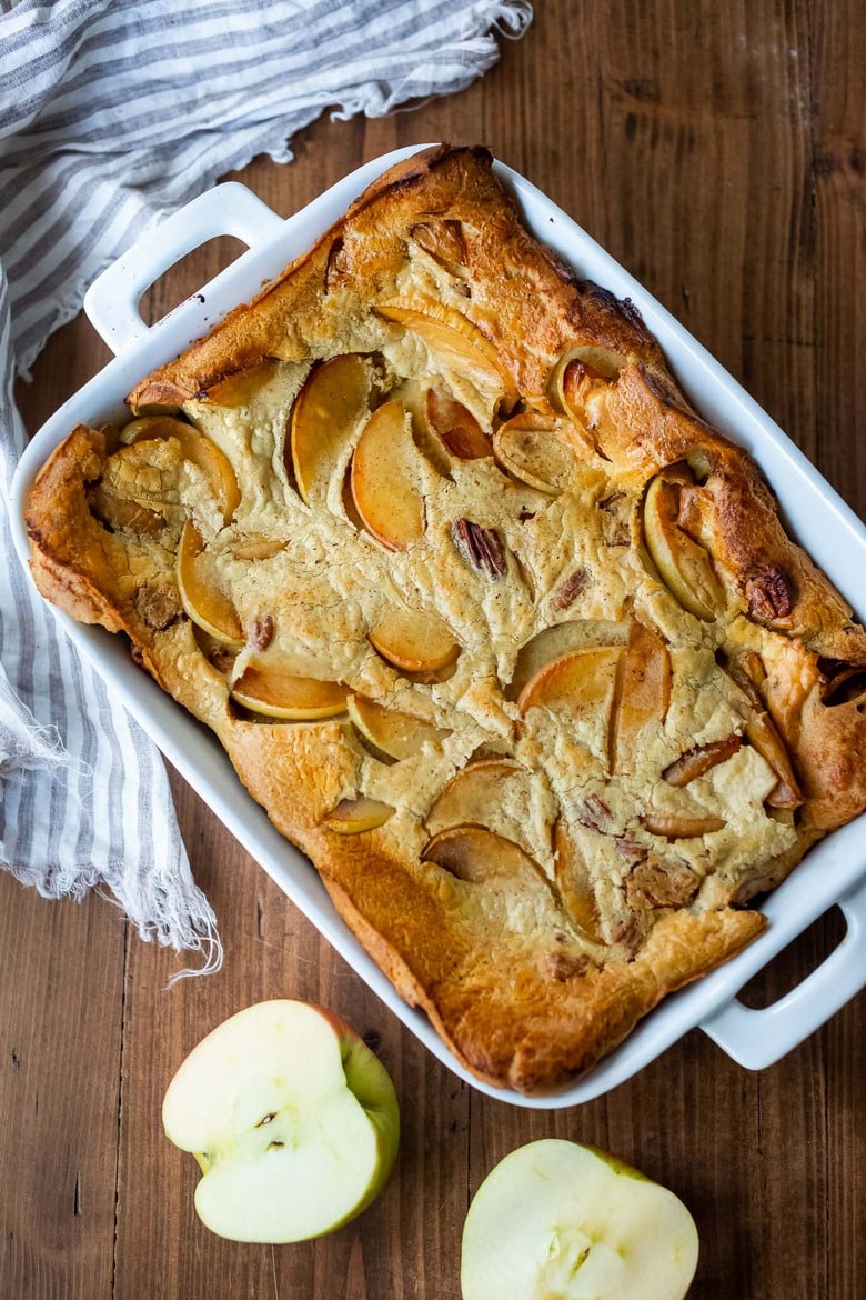 A simple recipe for Pannekoeken, a baked apple pancake "casserole" hailing from the Netherlands, this version is infused with cardamom and nutmeg and puffs up dramatically in the oven. A delicious weekend breakfast or brunch. #breakfast #brunch #applepancake 