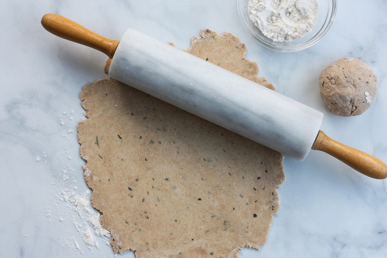 rolling out sourdough discard dough