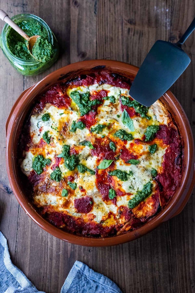 Eggplant Lasagna made with no-boil noodles and topped with Arugula Pesto. A delicious, healthy vegetarian dinner recipe that is comforting and nourishing. #vegetarian #eggplantlasagna #lasagna #healthycomefortfood