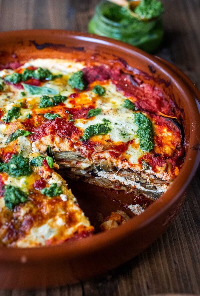 Eggplant Lasagna made with no-boil noodles and topped with Arugula Pesto. A delicious, healthy vegetarian dinner recipe that is comforting and nourishing. #vegetarian #eggplantlasagna #lasagna #healthycomefortfood