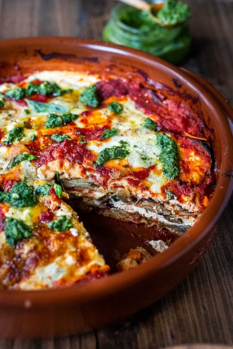 Eggplant Lasagna made with no-boil noodles and topped with Arugula Pesto. A delicious, healthy vegetarian dinner recipe that is comforting and nourishing. #vegetarian #eggplantlasagna #lasagna #healthycomefortfood