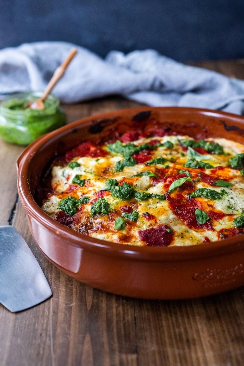 Eggplant Lasagna made with no-boil noodles and topped with Arugula Pesto. A delicious, healthy vegetarian dinner recipe that is comforting and nourishing. #vegetarian #eggplantlasagna #lasagna #healthycomefortfood