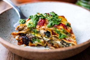 An EASY Eggplant Lasagna made with no-boil noodles and topped with Arugula Pesto. A delicious, healthy vegetarian dinner recipe that is comforting and nourishing.