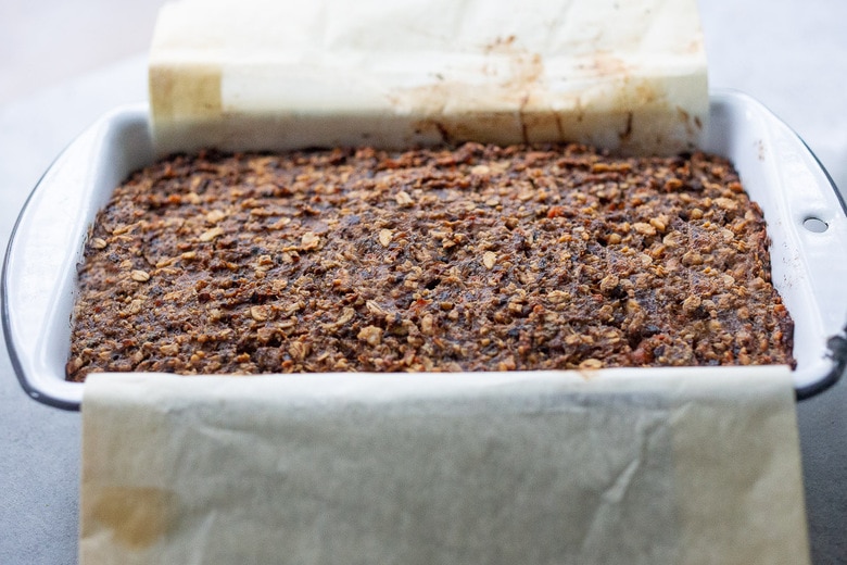 baked mushroom loaf in loaf pan with slightly puffed surface.