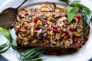 A savory vegetarian main dish, this Sagey Mushroom Walnut Roast ( aka Nut Loaf) is a beautiful addition to your holiday table. #nutloaf #mushroomloaf