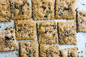 How to make homemade crackers from sourdough discard or starter.  A quick, easy and adaptable recipe.  These crackers are crisp, tangy and incredibly addicting! #sourdough #discard #crackers #crackersrecipe