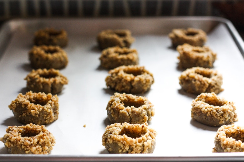 Thumbprint Cookies are a perfect treat for the holidays.  A melt in your mouth rustic thumbprint cookie with rye, toasty walnuts, cardamom and tangy apricot jam-  a perfect balance of flavors, decadent and lightly sweet with a satisfying crunch. #thumbprintcookies