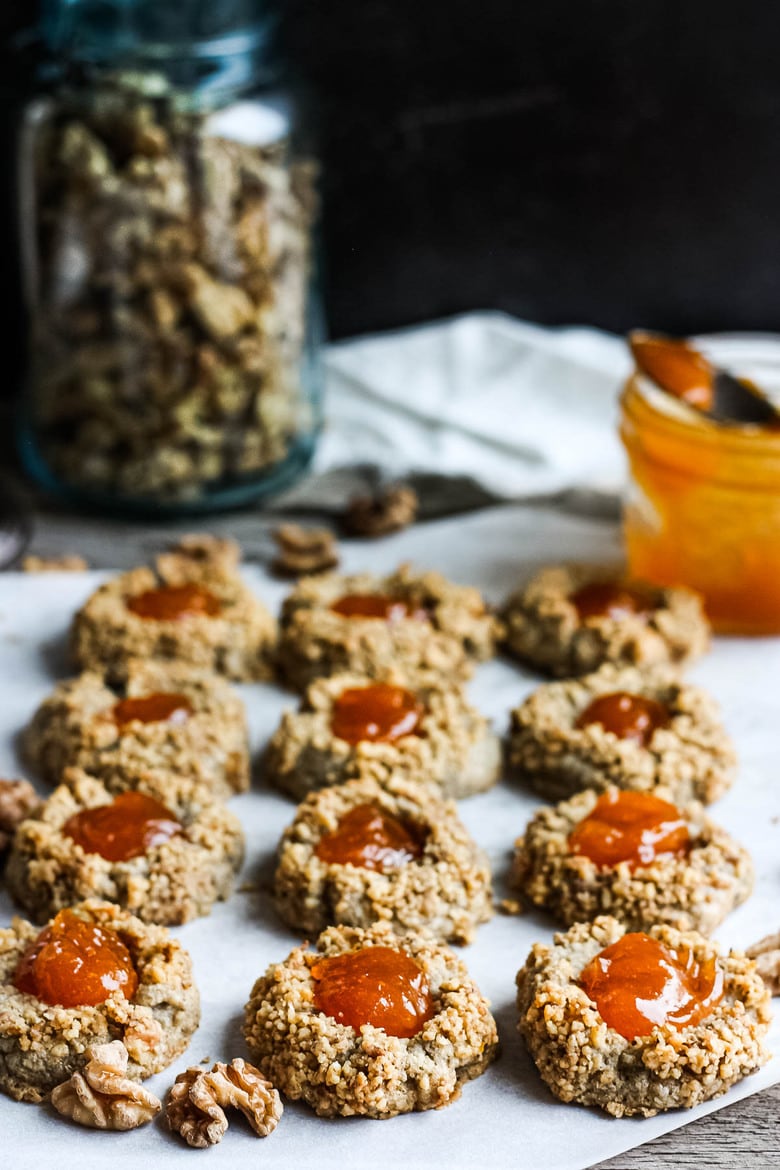 Thumbprint Cookies are a perfect treat for the holidays.  A melt in your mouth rustic thumbprint cookie with rye, toasty walnuts, cardamom and tangy apricot jam-  a perfect balance of flavors, decadent and lightly sweet with a satisfying crunch. #thumbprintcookies