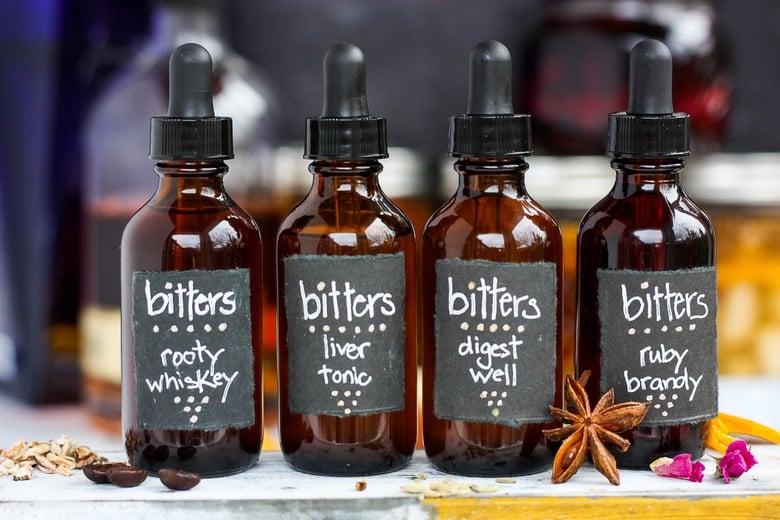 Learn how easy it is to make your own homemade bitters!  An important health tonic that can boost digestion, balance liver health and so much more.  Bitters add beautiful interest and depth to drinks and cocktails. A fun and easy project that takes very little hands-on time! Perfect for holiday gifts and stocking stuffers.