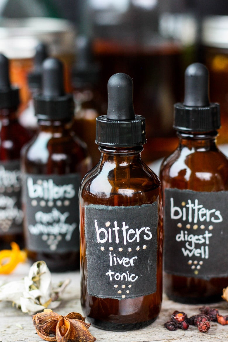 Learn how easy it is to make your own homemade bitters!  An important health tonic that can boost digestion, balance liver health and so much more.  Bitters add beautiful interest and depth to drinks and cocktails. A fun and easy project that takes very little hands-on time! Perfect for holiday gifts and stocking stuffers.