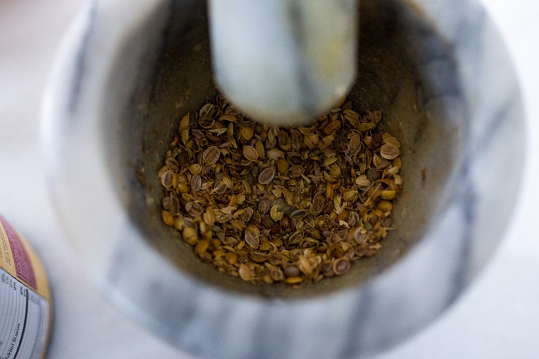 crushing the coriander seed