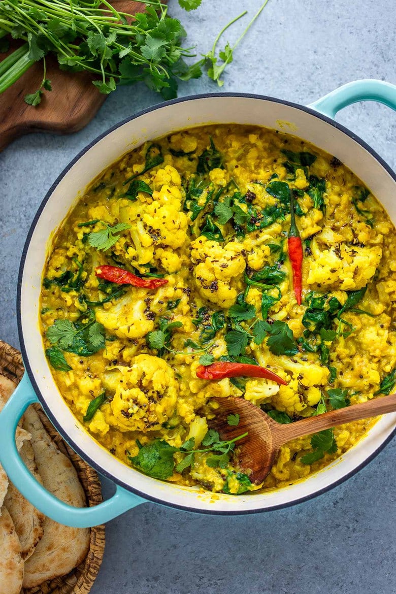 Cauliflower Dal with Coconut and Spinach made with split red lentils and fragrant Indian spices. A healthy comforting, plant-based dinner recipe. Vegan-adaptable. #dal #cauliflower #dalrecipe #lentils 