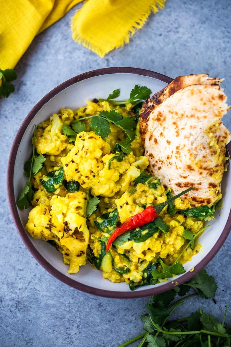 Golden Cauliflower Dal with Coconut and Spinach made with split red lentils and fragrant Indian spices. A healthy comforting, plant-based dinner recipe. Vegan-adaptable. #dal #cauliflower #dalrecipe #lentils 