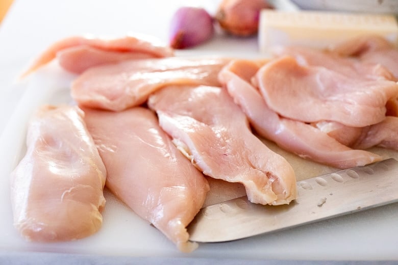 cutting the chicken into ½ inch thick pieces