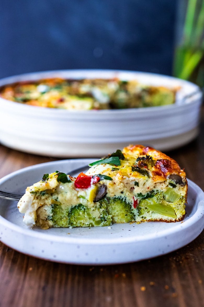 This delicious Baked Frittata is easy to make, full of healthy vegetables, and very versatile. It can be made ahead - perfect for a holiday breakfast or brunch, or serve it up for lunch or dinner -an easy, clean-out-the fridge kind of meal. This crustless quiche is Keto, Gluten-free and low-carb. #frittata #healthybreakfast
