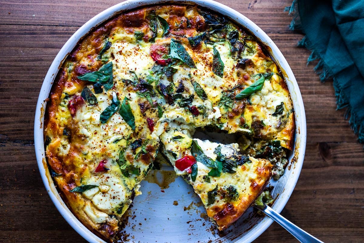 This delicious Baked  Frittata is easy to make, full of healthy vegetables, and very versatile. It can be made ahead - perfect for a holiday breakfast or brunch, or serve it up for lunch or dinner -an easy, clean-out-the fridge kind of meal. This crustless quiche is Keto, Gluten-free and low-carb. #frittata #healthybreakfast