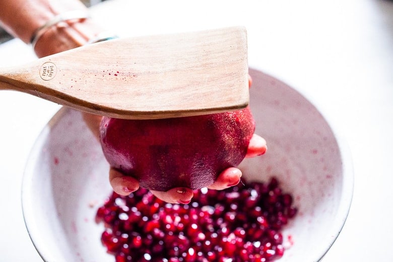 whack the pomegranate with a wood spoon