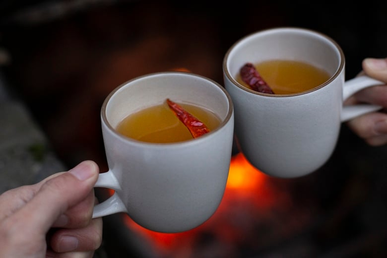 How to make a Hot Toddy at home, that we think is better than most of the professional versions you're likely to encounter! This recipe uses mezcal, lime juice & honey - but you can easily swap those out for the traditional whiskey with lemon - or nearly any other base spirit, citrus & spice combination that suits your tastes.  #hottoddy