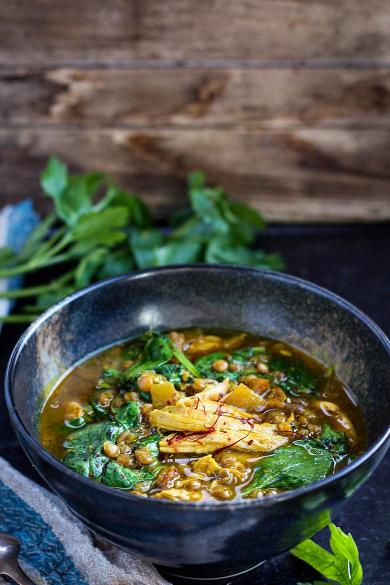 A richly spiced Moroccan-inspired soup, full of flavor, nutrients and soul-warming color.  Saffron, dried apricots and preserved lemon give this brothy Chicken Lentil Soup it's depth. Easy to throw together, perfect for weeknight dinners. #moroccanchickensoup #moroccanlentilsoup #chickenlentilsoup #healthysoup #lentilsoup
