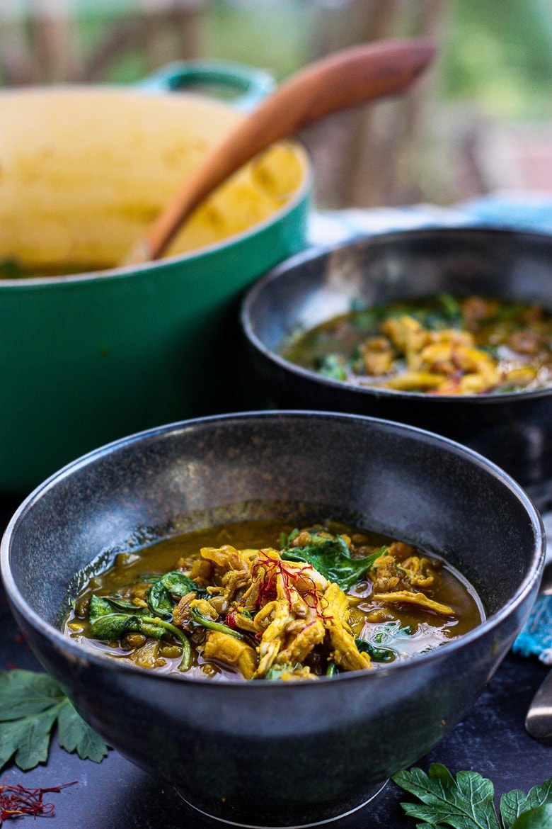 A richly spiced Moroccan-inspired soup, full of flavor, nutrients and soul-warming color.  Saffron, dried apricots and preserved lemon give this brothy Chicken Lentil Soup it's depth. Easy to throw together, perfect for weeknight dinners. #moroccanchickensoup #moroccanlentilsoup #chickenlentilsoup #healthysoup #lentilsoup