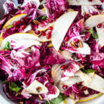 A simple, festive Radicchio Salad with fruit, nuts, and optional cheese in a delicious champagne vinaigrette. 