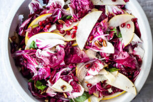 A simple, festive Radicchio Salad with fruit, nuts, and optional cheese in a delicious champagne vinaigrette. 