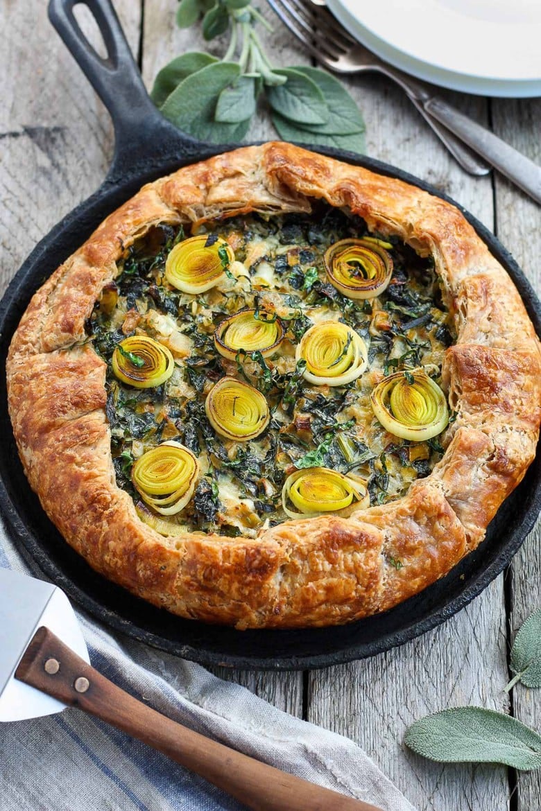 A Savory Galette filled with a luscious mixture of leeks, kale and mascarpone, enclosed in a free-formed, tender, extra flakey crust. #galette #savorygalette #tart #leeks 