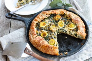 Beautiful and delicious Savory Leek Galette.   Made with a free-formed tender flakey crust enclosing a luscious melt in your mouth succulent filling. Leeks and kale marry with gruyere and mascarpone making the perfect balance of decadent and wholesome! The Galette dough is the secret here! #galette #savorygalette #tart #leeks