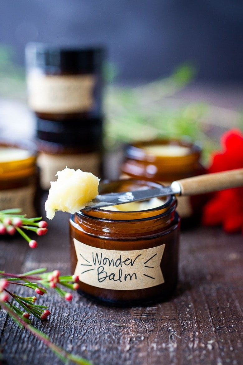 How to make a creamy Shea Butter Body Balm to sooth dry winter skin, tame locks, heal cracked lips, and moisturize dry hands and feet. Made with simple all natural ingredients, scented with your choice of essential oils. #balm #salve #bodybutter