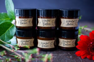 How to make a luscious, creamy Shea Butter Body Balm to sooth dry winter skin, tame locks, heal cracked lips, and moisturize dry hands and feet. Made with simple all natural ingredients, scented with your choice of essential oils. #balm #salve #bodybutter