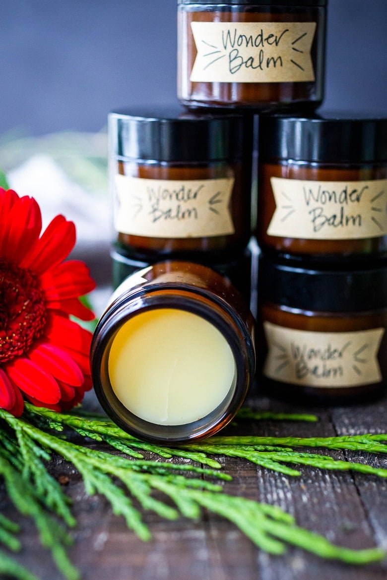 How to make a luscious, creamy Shea Butter Body Balm to sooth dry winter skin, tame locks, heal cracked lips, and moisturize dry hands and feet. Made with simple all natural ingredients, scented with your choice of essential oils. #balm #salve #bodybutter