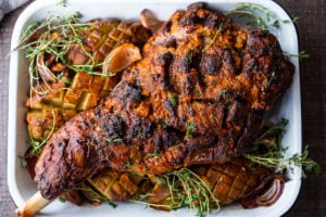 A simple recipe for Leg of Lamb with a Harissa Yogurt Crust. This bone-in lamb leg yields a beautiful flavorful crust with juicy tender meat. #legoflamb #lamb #fanoflamb #lambroast #harrisa