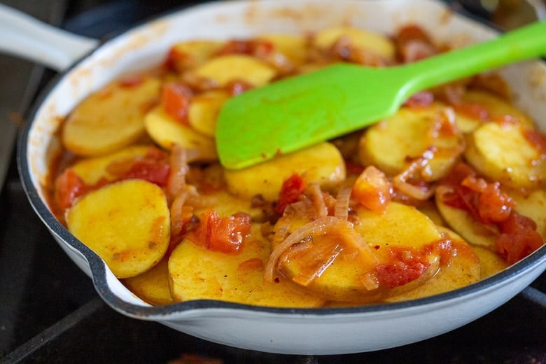 add the potatoes to the pan with the broth