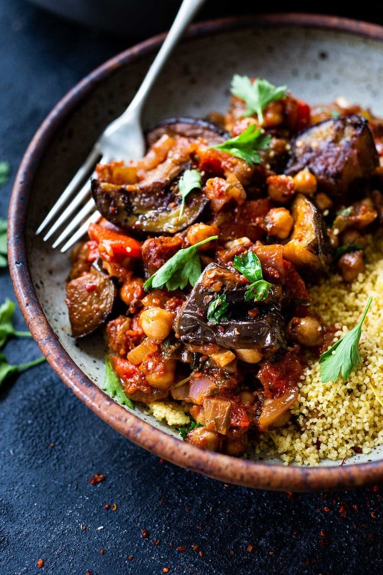 A simple delicious Tagine Recipe with Eggplant and Chickpeas infused with Moroccan spices, served over cinnamon-scented couscous. This flavorful Eggplant Chickpea Stew is vegan and gluten-free. 