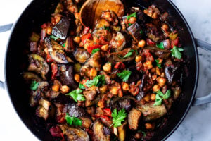 Delicious, Healthy Tagine Recipe with Eggplant and Chickpeas- seasoned with Moroccan spices and served over couscous. A simple plant-based dinner recipe! #tagine