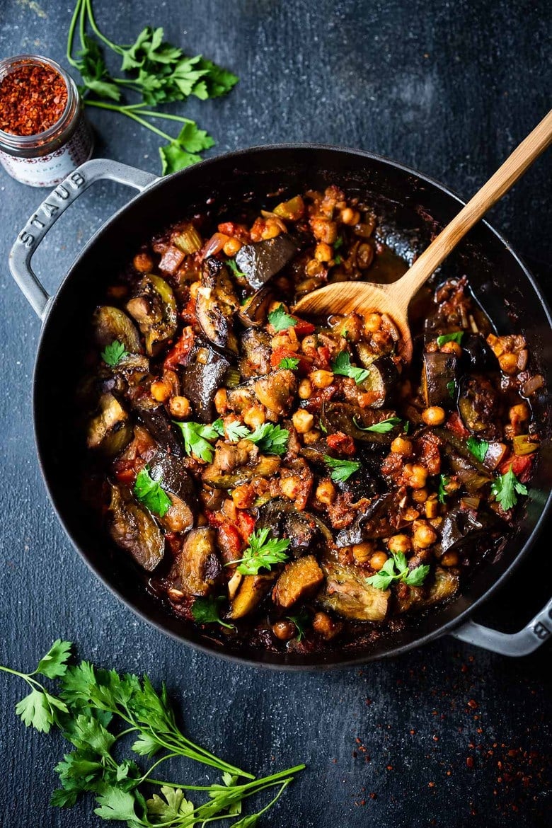 Flavorful Tagine Recipe with Eggplant and Chickpeas- seasoned with Moroccan spices and served over couscous. A simple plant-based dinner recipe! 