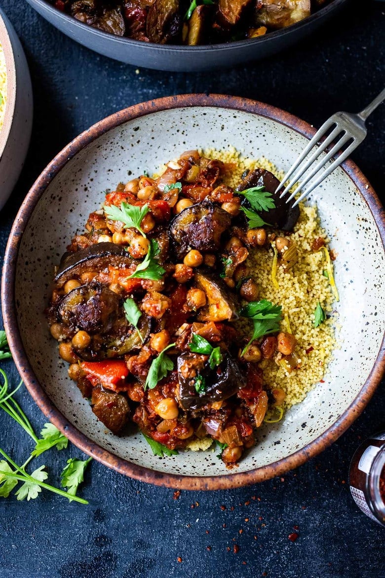 Delicious, Healthy Tagine Recipe with Eggplant and Chickpeas- seasoned with Moroccan spices and served over couscous. A simple plant-based dinner recipe! #tagine