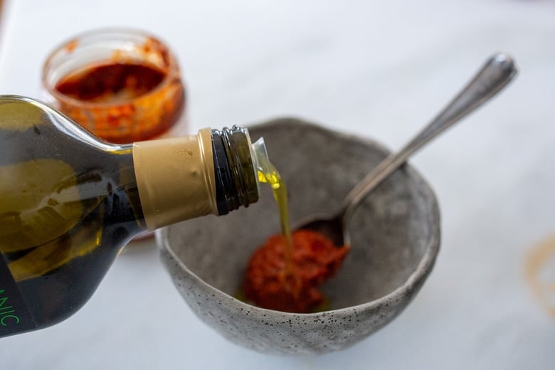 make the harissa oil by stirring harissa paste with olive oil. 