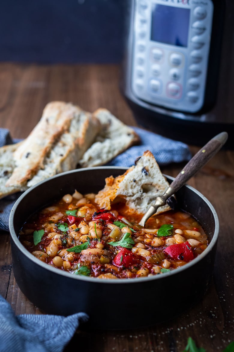 Smoky Tomato White Bean Soup, you can make in your Instant Pot or on the stovetop using dry beans. Smoked paprika and optional Harissa paste give it a delicious flavor that will have you coming back for seconds.  Low in calories, high in fiber, this soup is vegan and gluten-free.