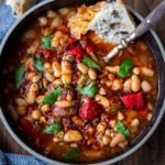 Our BEST instant Pot recipes! Smoky Tomato White Bean Soup with roasted peppers and optional harissa oil, made with dry beans in an instant pot or on the stove top. Vegan and gluten free.