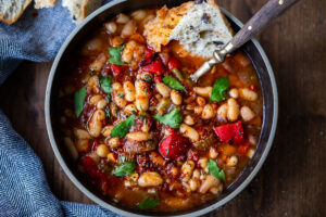 Our BEST instant Pot recipes! Smoky Tomato White Bean Soup with roasted peppers and optional harissa oil, made with dry beans in an instant pot or on the stove top. Vegan and gluten free.