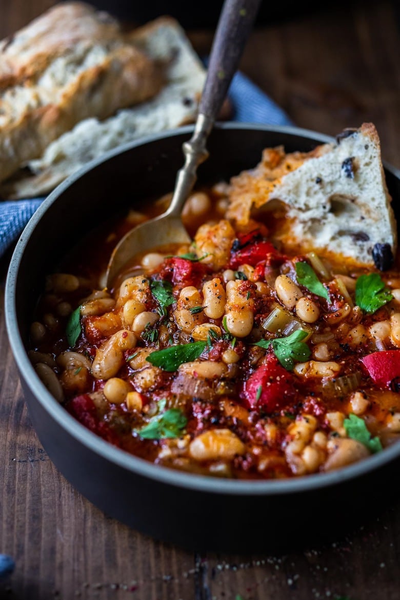 Here's a simple, hearty White Bean Soup you can make in your Instant Pot or on the stovetop using dry beans. Smoked paprika and optional Harissa paste give it a delicious flavor that will have you coming back for seconds.  Low in calories, high in fiber, this soup is vegan and gluten-free. #whitebeansoup 