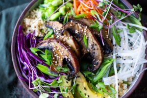Miso Mushroom Bowl with brown rice, avocado, cabbage, carrots, daikon, edamame and a Miso Ginger Dressing. Vegan and Gluten free.