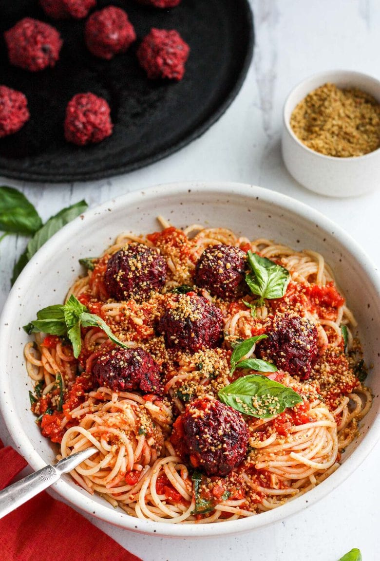 Vegan Spaghetti and Beetballs! A beautiful twist on the comforting familiar classic. Beets, black beans, walnuts and basil make these plant-based meatballs scrumptious and so satisfying. Top with an easy rustic tomato sauce for a meal the whole family will love! #vegan #veganmeatballs #beetballs #spaghetti #veganspaghetti